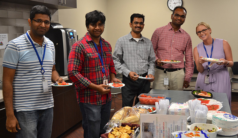 Staff surrounding table with healthy food