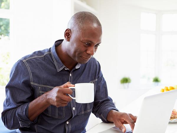 Man at table looking at computer