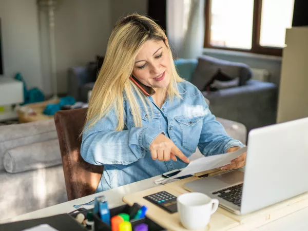 Woman on phone call, sitting at desk