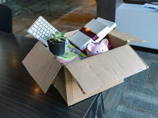 Box of office supplies sitting on desk