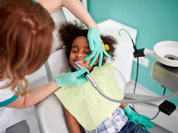 A little girl getting a cleaning at the dentist