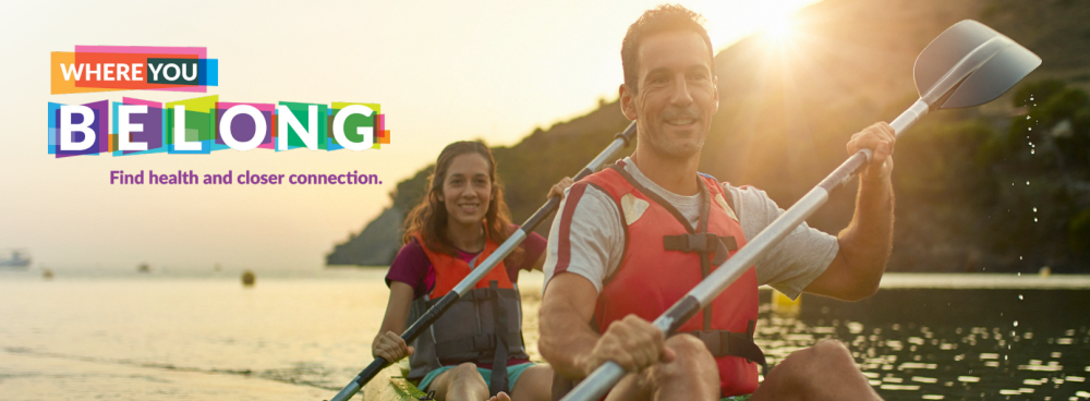 Photo of woman and man canoeing, with background texts, "WHERE YOU BELONG: Find health and closer connection.