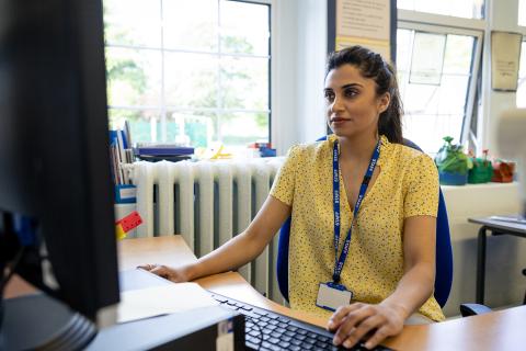 young teacher seated at computer