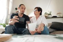 Man holding phone with mother